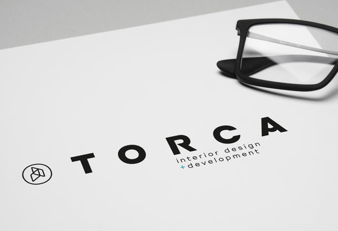 Brand identity for Torca. The company logo is printed on stationary