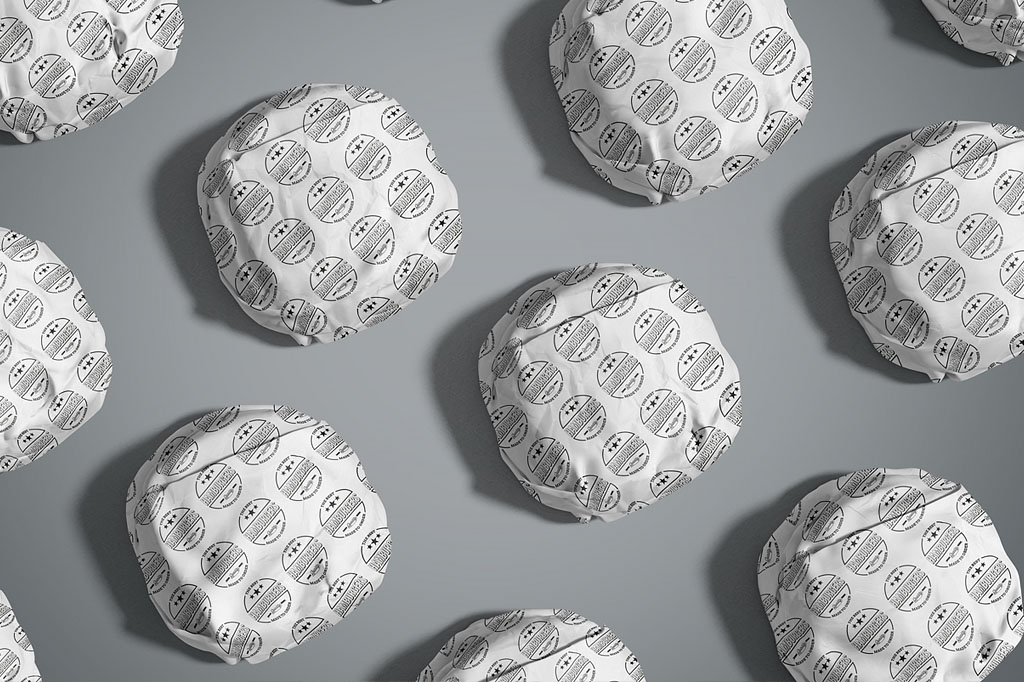 Gourmet burgers wrapped in custom branded paper featuring retro hamburger logo design for Sofia Frankston kiosk hospitality branding Melbourne