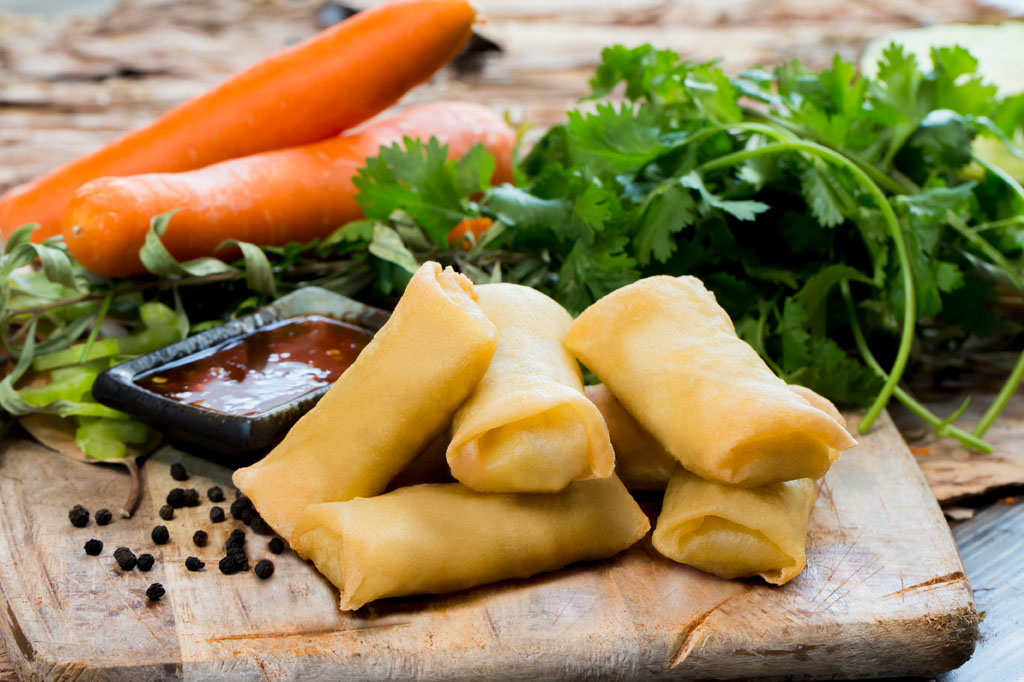Emperor Chicken and Vegetable Spring Rolls showcased with rustic ingredient photography supporting authentic food branding and packaging design Melbourne