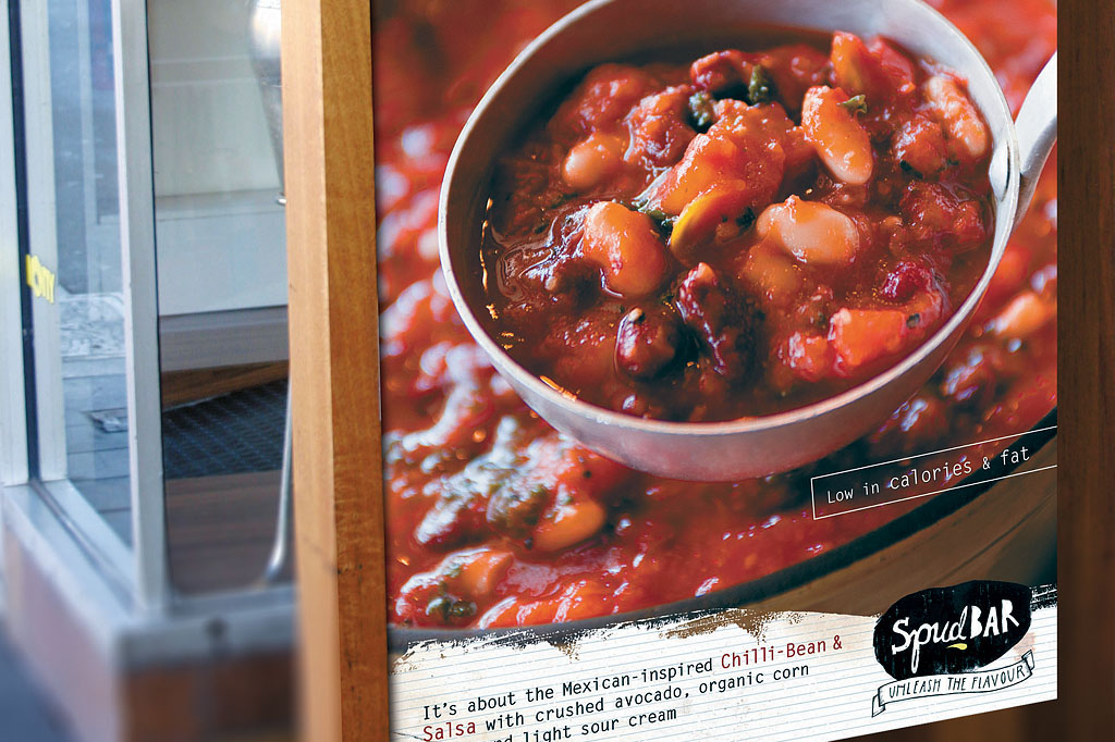 Spudbar outdoor promotional signage highlighting Chilli Bean and Salsa gourmet potato meal with healthy messaging and restaurant branding by Melbourne freelance designer